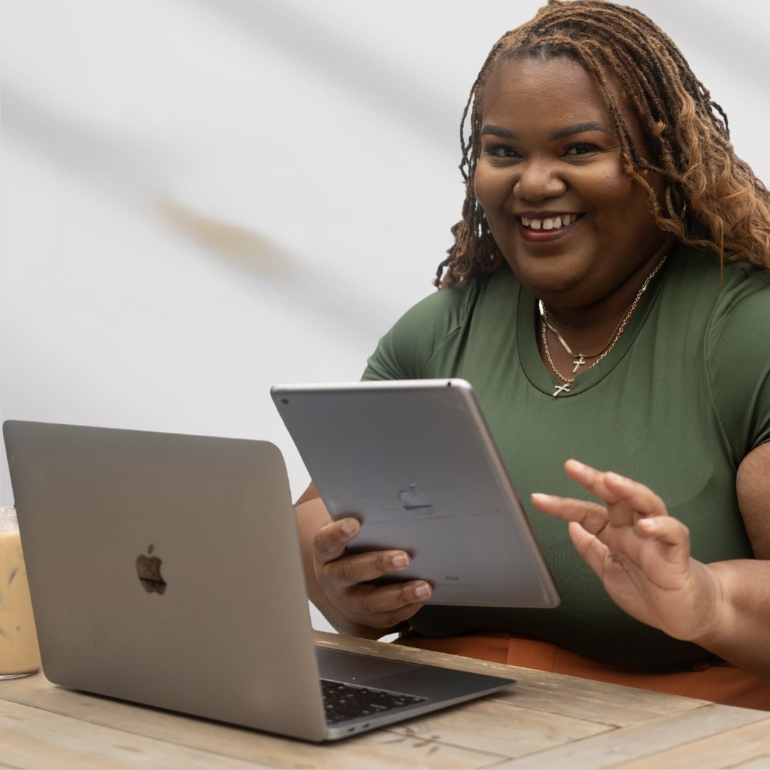 Alia Freeman teaching with a tablet and laptop